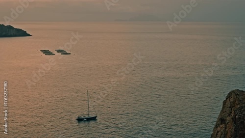 Golden sunset over atlantic bay near madeira island portugal filmed in wide shot with anchored sailboats and rugged hills