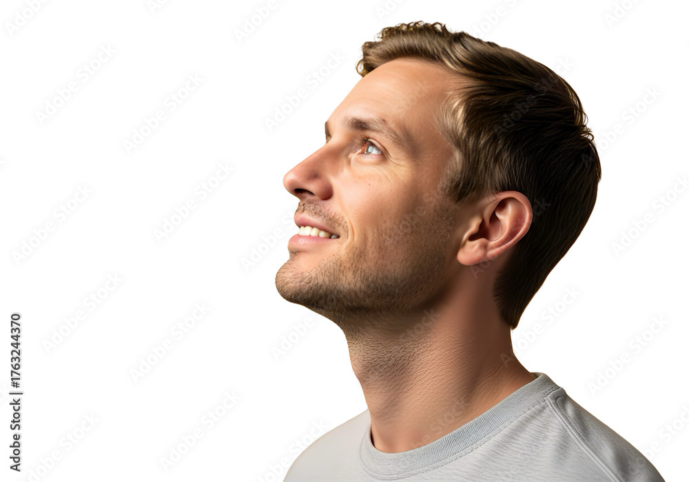 Obraz premium Smiling young man looking upward with hopeful expression, side profile isolated on white background