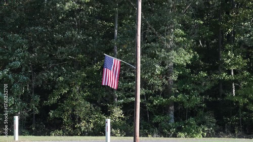 Leonardtown, Maryland, USA A US flag flies from a telephone pole in the sun.