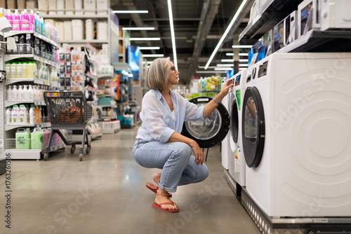 Exploring options in a home appliances store while considering a new washing machine