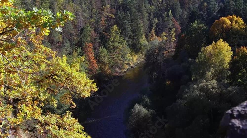 Flying above Vltava river curve in autumn colorful Czech valley landscape. Aerial view