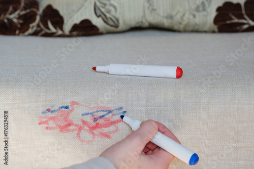 Blue marker in vibrant colors used to create abstract designs on a textured fabric surface.The surface light fabric shows intricate texture as the cleaning care. Daily stains concepеt