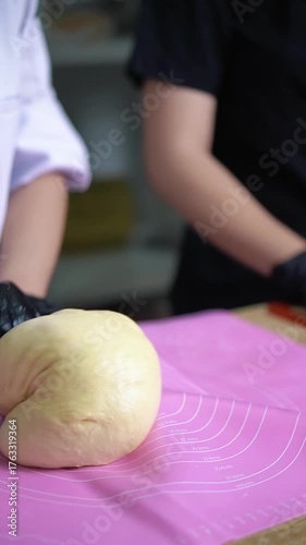 an arm is making bread dough in the kitchen