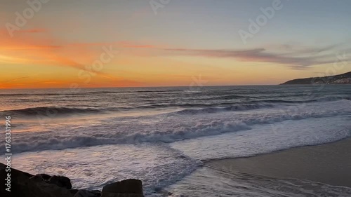 Golden sunset over Atlantic ocean with waves and rocks at Figuera da Foz, Portugal. Sunset, waves and beach without people.Video