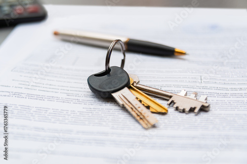 New house keys on paperwork showing the excitement of buying real estate in a welcoming neighborhood