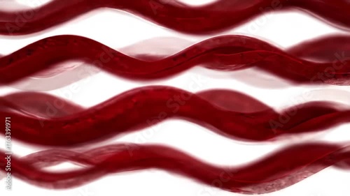 Abstract closeup of red wavy lines creating a dynamic and flowing pattern against a bright white background suggesting movement and artistic design.