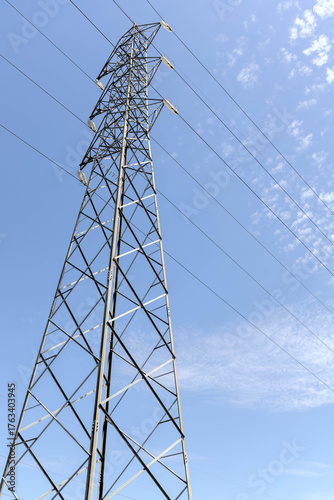 High voltage post. High-voltage tower on blue sky background.