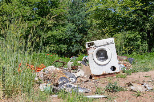 Abandoned Washing Machine on the ground in the countryside.