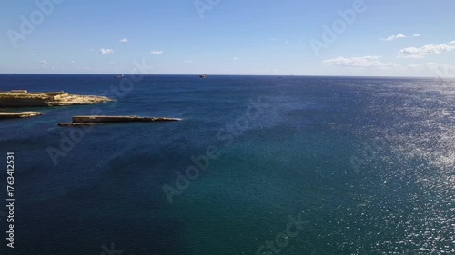 AERIAL drone shot: Limestone Wall of Ta Kalanka Sea Cave Bay with Turquoise Color Sea