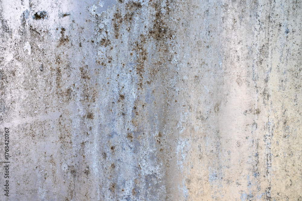 Obraz premium An abstract grunge texture background of an old, weathered stainless steel surface. The faded, stained, and mossy metal creates a rough, authentic, and industrial pattern.