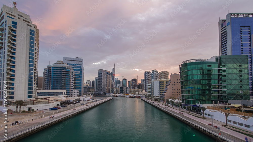 Obraz premium Dubai Marina towers and canal in Dubai night to day timelapse