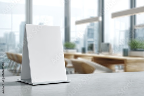 Wallpaper Mural An empty white tabletop sign stands on a surface, with a blurred interior and city view Torontodigital.ca