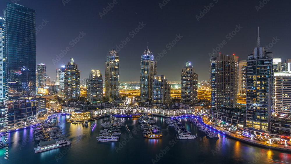 Fototapeta premium Dubai Marina skyscrapers aerial day to night timelapse, port with luxury yachts and marina promenade