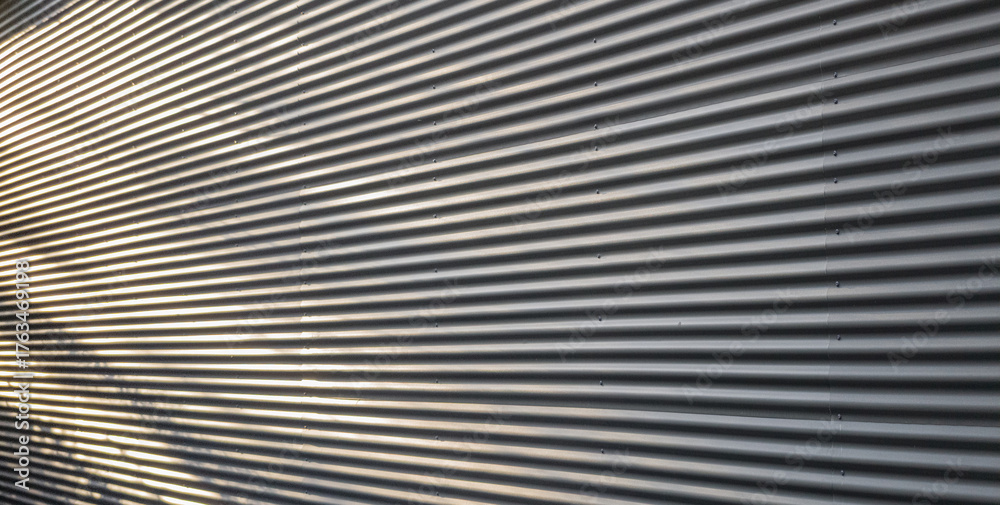 Fototapeta premium Corrugated Metal Wall Texture with Dynamic Shadows and Highlights