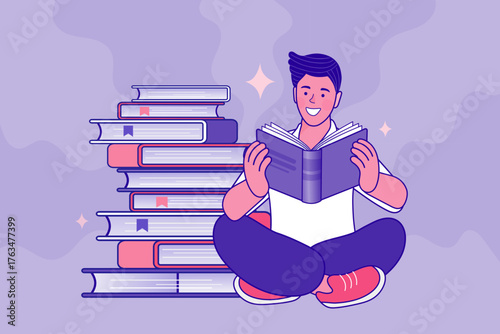 A happy young man sits cross-legged, engrossed in reading a book. He is next to a large stack of books, symbolizing education, knowledge, and a love for studying at a library or university.