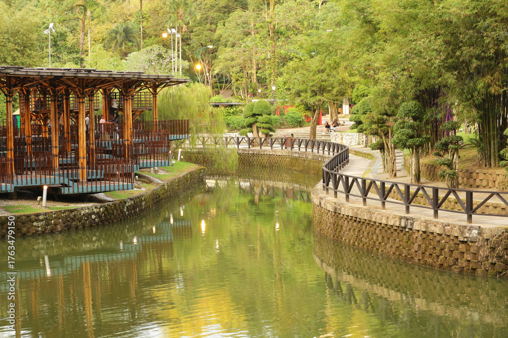Leisure area by a decorative pond in a Kuala Lumpur park