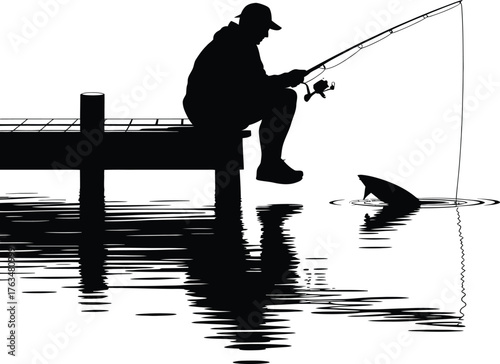 Silhouette of a man fishing from a dock with fish in the water