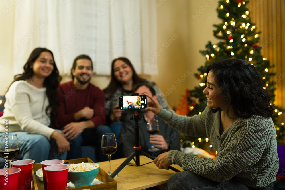 Obraz premium Friends taking group selfie at christmas holiday party