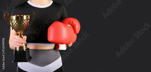 Female boxer with gold cup ...