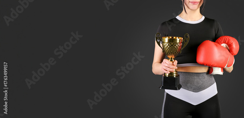 Female boxer with gold cup ...