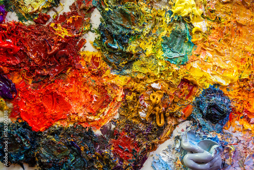 Close-up of an oil painting palette with thick, textured paint. Abstract art and creative inspiration.
