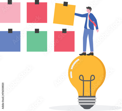 Businessman attaching a paper to a noteboard next to a lamp,
