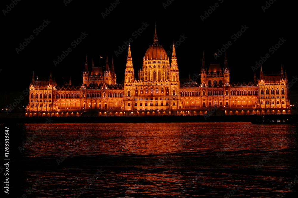 Fototapeta premium Illuminated Hungarian Parliament Building reflecting on the Danube River at night, Budapest