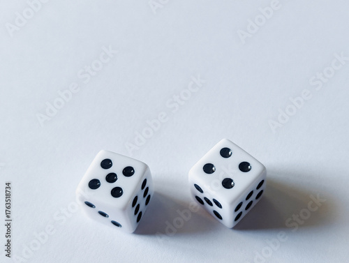 horizontal conceptual photo of two white dice showing five and four on a clean white background