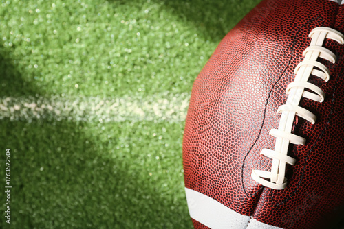 American football ball on g...