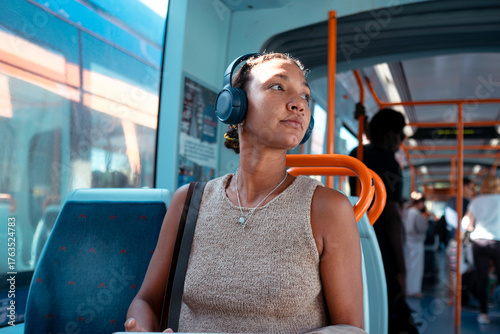 Young woman listening music while commuting on public transport