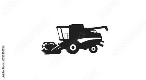Silhouette of a combine harvester on a farm field