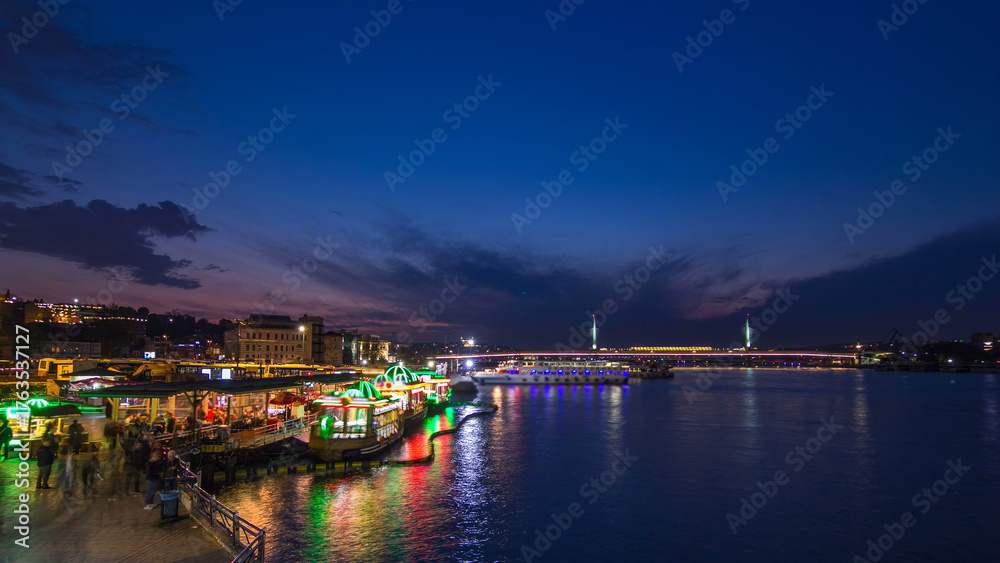 Fototapeta premium Passenger Ferries in the Golden Horn after sunset day to night timelapse, Istanbul skyline, Turkey