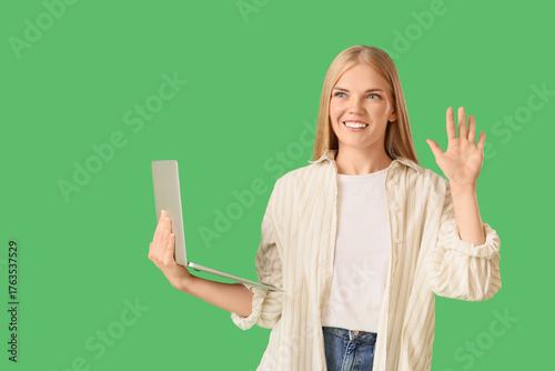 Young woman with laptop wav...