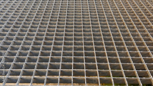 Metal grate floor with rectangular cells, perspective view. Horizontal background.