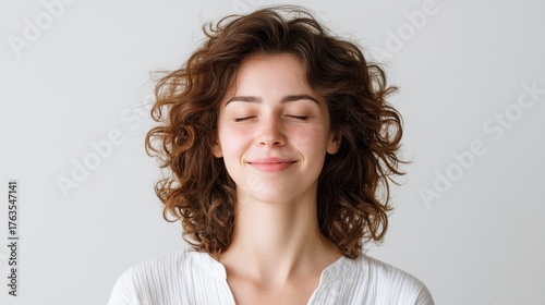A close-up of a person face with eyes closed and a gentle smile, symbolizing a balanced and happy life. Mindfulness, positive thinking, and a growth mindset.