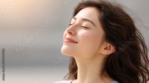 A close-up of a person face with eyes closed and a gentle smile, symbolizing a balanced and happy life. Mindfulness, positive thinking, and a growth mindset.