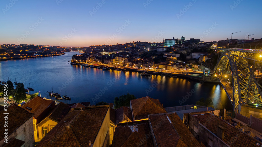 Obraz premium Panorama of old city Porto at river Duoro after sunset day to night timelapse, Oporto, Portugal