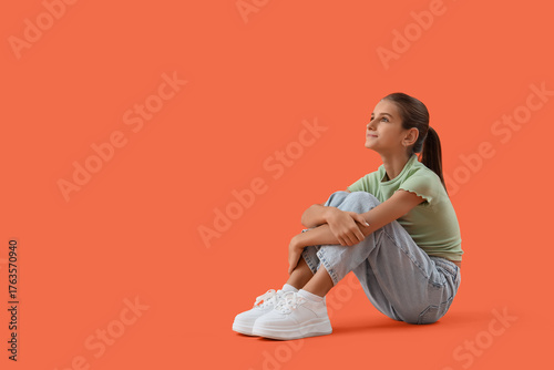 Dreamy teenage girl sitting...
