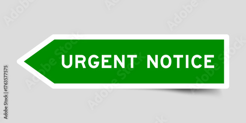 Green color arrow shape sticker label with word urgent noticeon gray background