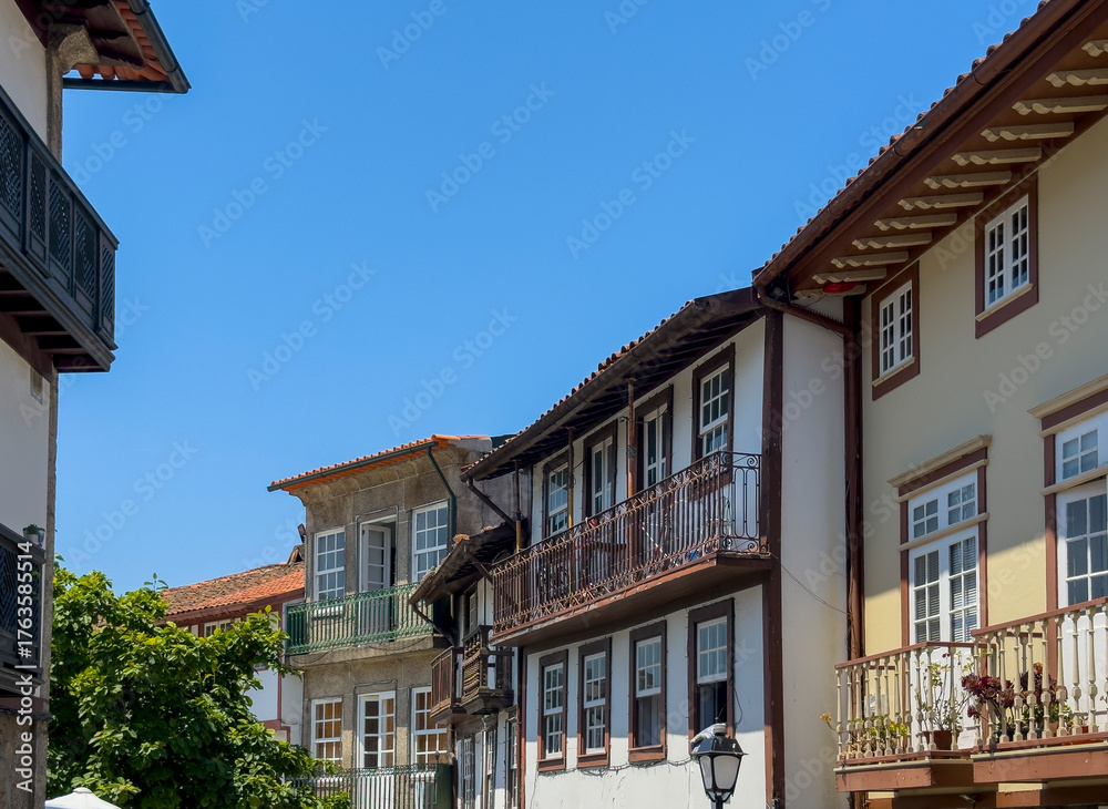 Fototapeta premium Picturesque old European city street with colorful historic buildings and stone facades. Quiet