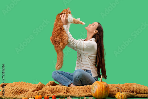 Young woman with cute cat a...