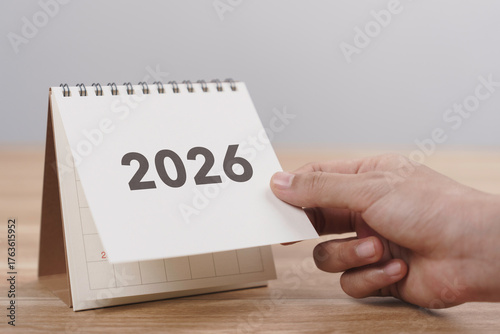 Wallpaper Mural Business woman hand change 2026 Year Calendar on table in office background. countdown to Happy New Year, Year End and New Start, Resolution and Goals Plan Action Concept. Schedule in 2026 Torontodigital.ca