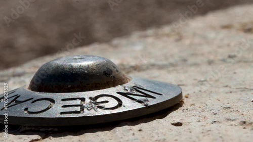 Teruel, Spain, 04-15-2023 Measuring point on the street, brass topographic marker to take very exact measurements of the latitude, longitude and height at which it is located, geodesic vertex