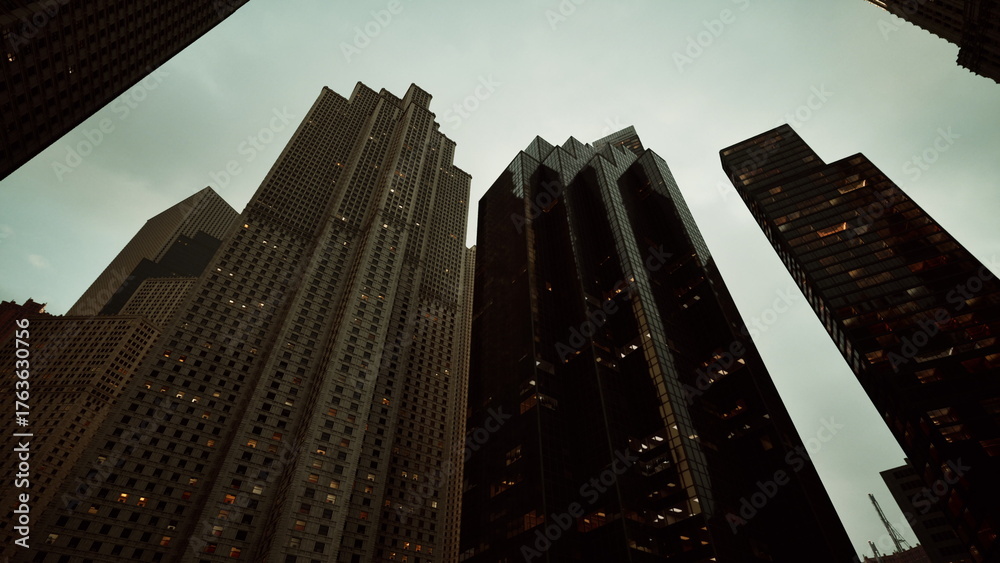 Φωτογραφία Tall buildings rise sharply from the ground, their glass and concrete facades reflecting the fading light