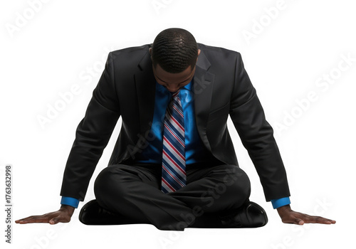 Businessman in suit and tie sits in defeated pose emotionally exhausted transparent background
