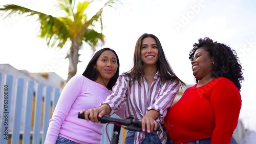 Happy latin women laughing and hugging each other outdoor in the city - Millennial girls and friendship concept