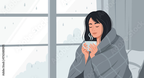 A Cozy Moment: Woman Wrapped in Blanket Enjoying Warm Beverage By A Window