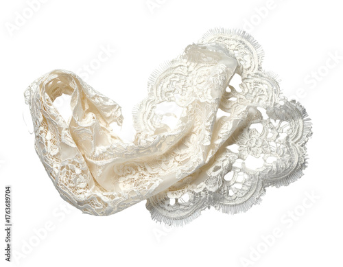 Ivory lace textile draped, intricate patterns and scalloped edges on dark backdrop
