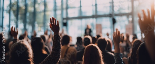 The Audience Engaged at a Conference Raising Hands During a Seminar Presentation