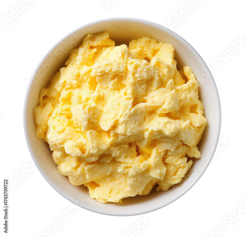 Scrambled eggs in bowl preparing breakfast meal